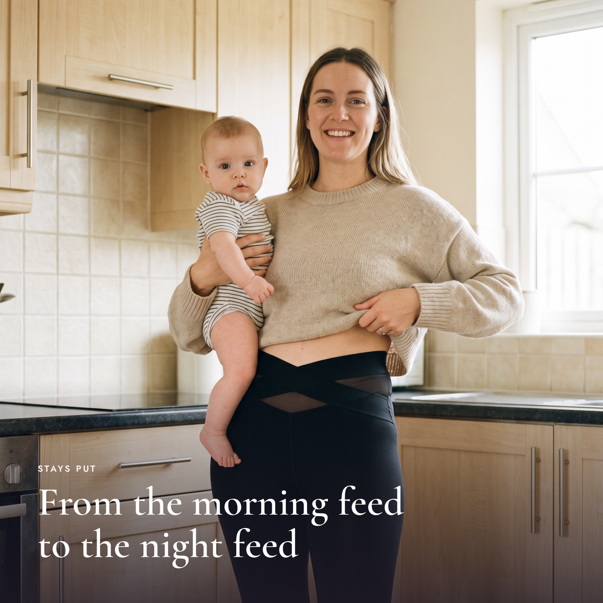 Mom holding her baby in the kitchen wearing the brief under leggings
